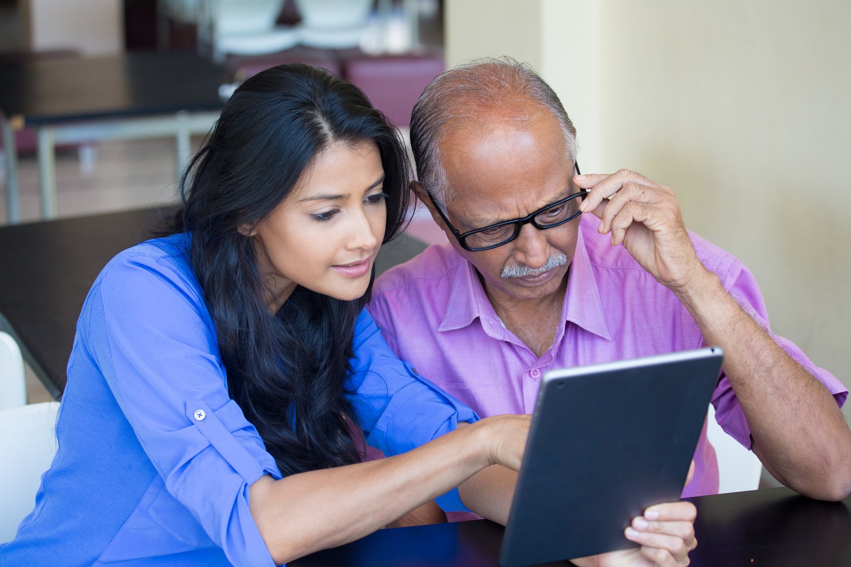 Woman Teaching Technology to Old Man